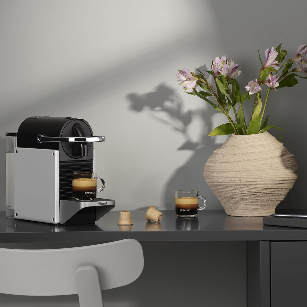 Nespresso Pixie Single Serve Pod Espresso Machine Aluminum By De'Longhi. Compact espresso machine, 19-bar pressure, fast heat-up, 2 cup sizes, brews the full range of espressos.